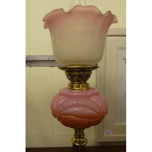 333 - A late Victorian oil lamp with a pink glass reservoir, a brass column and porcelain plinth  16