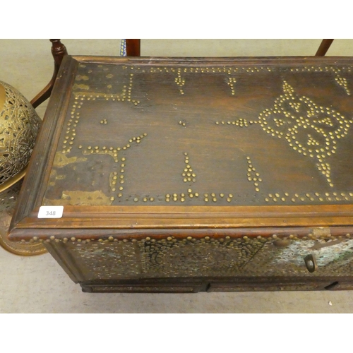 348 - An Asian hardwood chest with profusely applied and rivetted brass ornament with straight sides, a hi... 