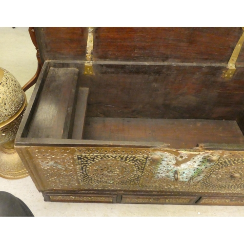 348 - An Asian hardwood chest with profusely applied and rivetted brass ornament with straight sides, a hi... 