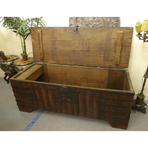 353 - A 17thC low Country oak boarded chest, extensively rivetted iron strapwork, studs and hinges, a clas... 