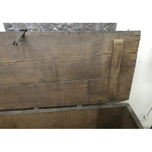 353 - A 17thC low Country oak boarded chest, extensively rivetted iron strapwork, studs and hinges, a clas... 