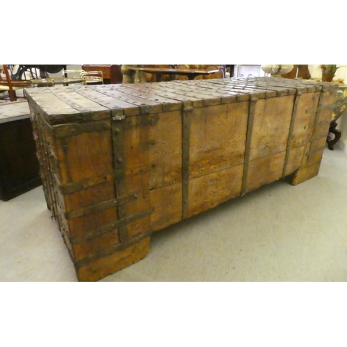 353 - A 17thC low Country oak boarded chest, extensively rivetted iron strapwork, studs and hinges, a clas... 