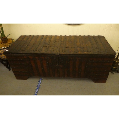 353 - A 17thC low Country oak boarded chest, extensively rivetted iron strapwork, studs and hinges, a clas... 