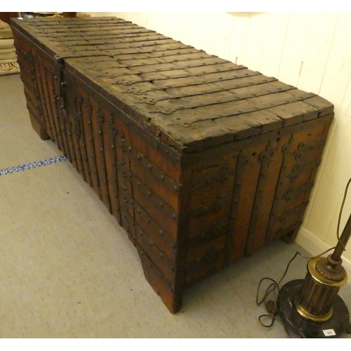 353 - A 17thC low Country oak boarded chest, extensively rivetted iron strapwork, studs and hinges, a clas... 