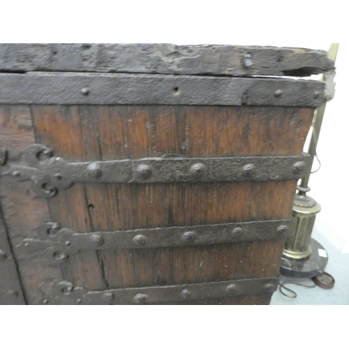 353 - A 17thC low Country oak boarded chest, extensively rivetted iron strapwork, studs and hinges, a clas... 