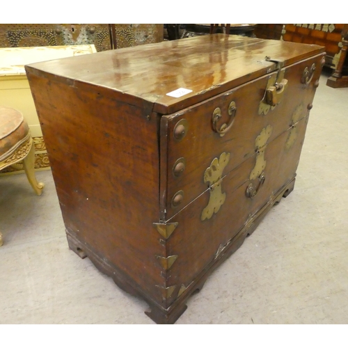 354 - A Chinese elm cabinet with a hinged front, raised on bracket feet  20