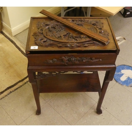 58 - A mid 20thC Chinese rosewood side table, the hinged lid ornately carved with an Oriental landscape a... 