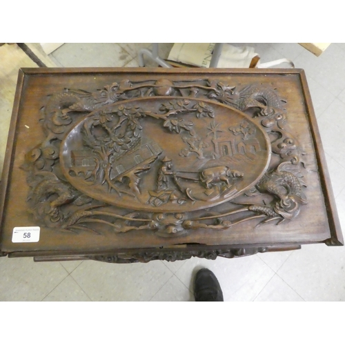 58 - A mid 20thC Chinese rosewood side table, the hinged lid ornately carved with an Oriental landscape a... 