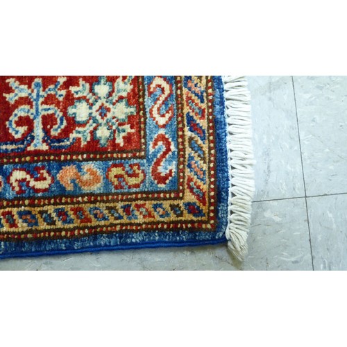 24 - A pair of Persian rugs, decorated with repeating stylised designs, on a multi-coloured ground  32