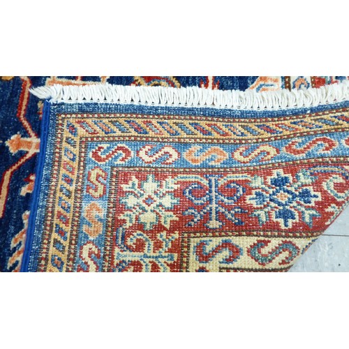 24 - A pair of Persian rugs, decorated with repeating stylised designs, on a multi-coloured ground  32