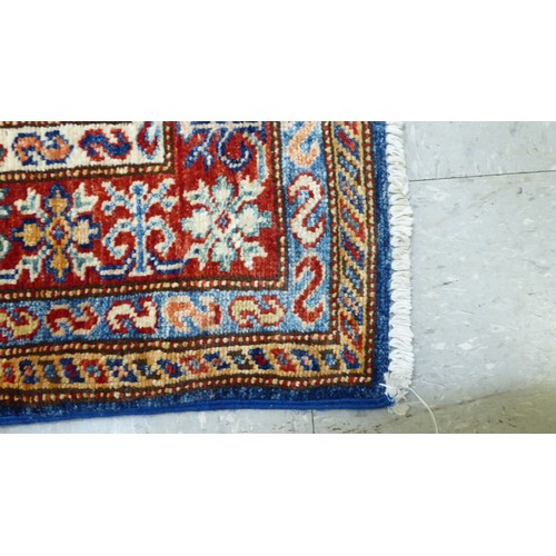 24 - A pair of Persian rugs, decorated with repeating stylised designs, on a multi-coloured ground  32