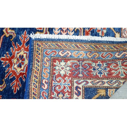 24 - A pair of Persian rugs, decorated with repeating stylised designs, on a multi-coloured ground  32