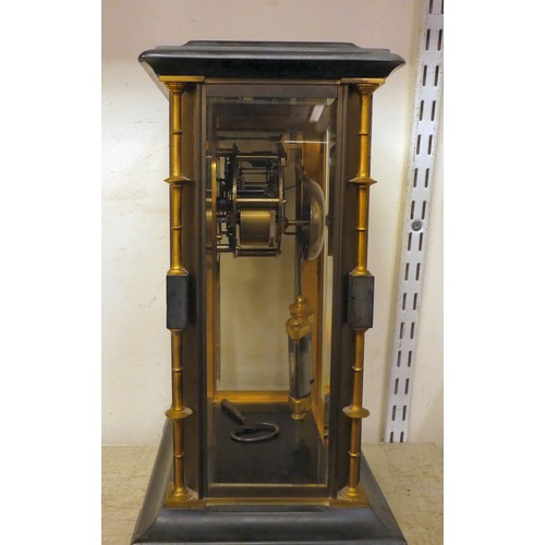 142 - A late Victorian four glass and black slate cased mantel clock with bevelled panels, integral, outse... 