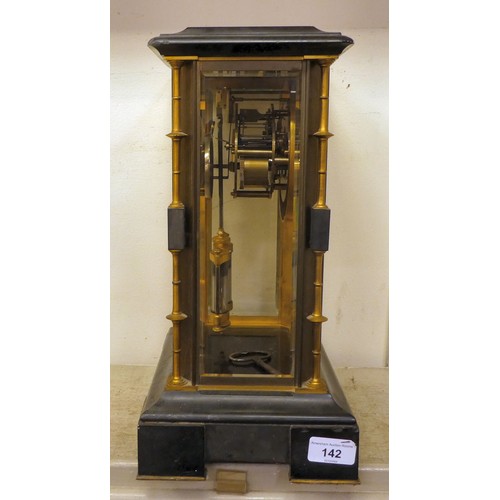 142 - A late Victorian four glass and black slate cased mantel clock with bevelled panels, integral, outse... 