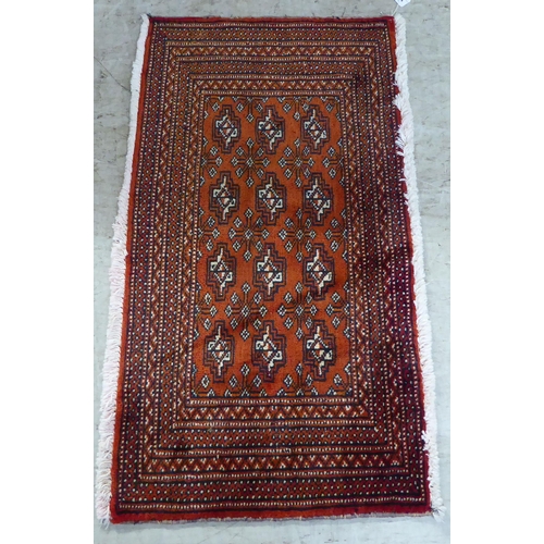 114 - A Persian design rug, decorated with geometric patterns, on a red ground  40