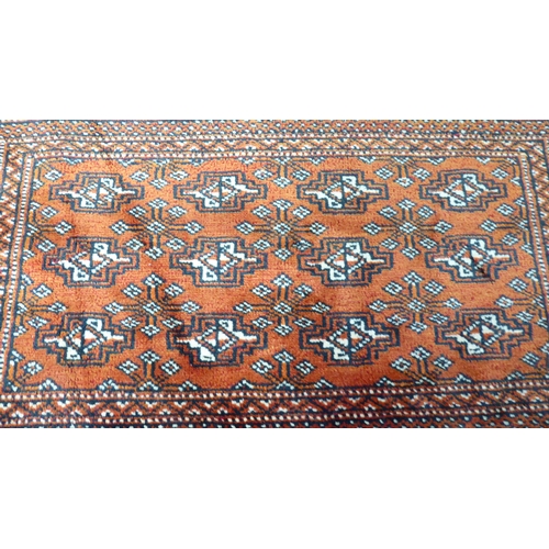 114 - A Persian design rug, decorated with geometric patterns, on a red ground  40