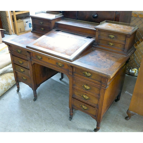 12 - An Edwardian mahogany three piece desk, comprising an arrangement of open shelves, drawers, hinged l... 