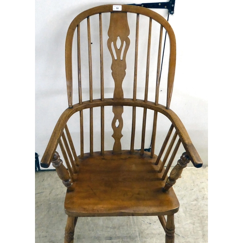 14 - A modern oak framed hoop, spindled and pierced splat back Windsor chair, the solid seat raised on tu... 