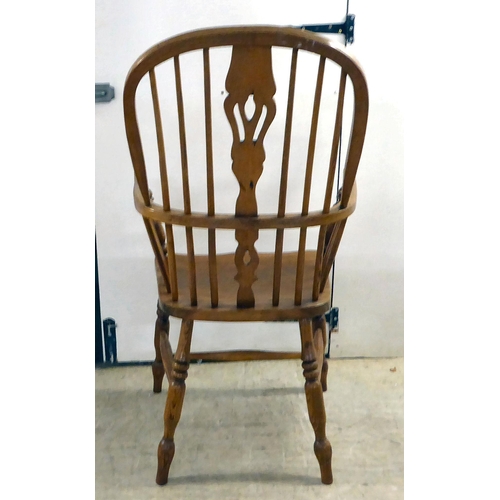 14 - A modern oak framed hoop, spindled and pierced splat back Windsor chair, the solid seat raised on tu... 