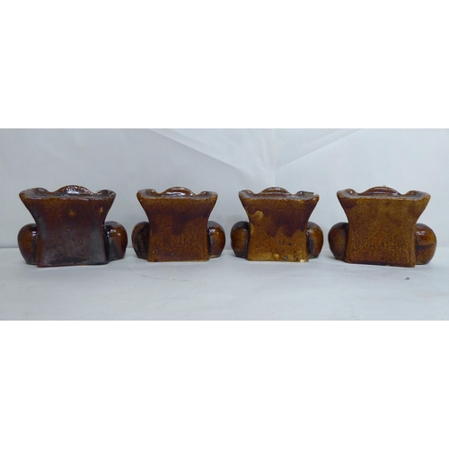 21 - A set of four pottery furniture risers  3.5