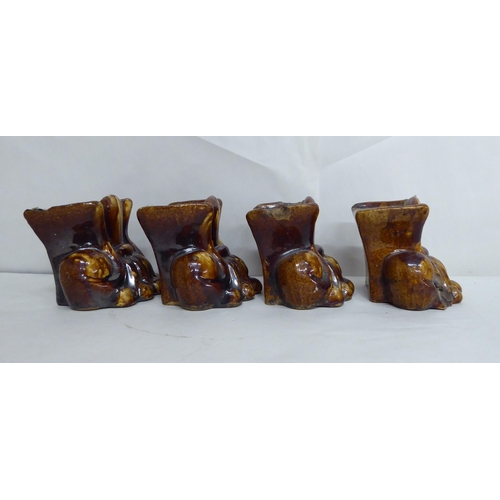 21 - A set of four pottery furniture risers  3.5