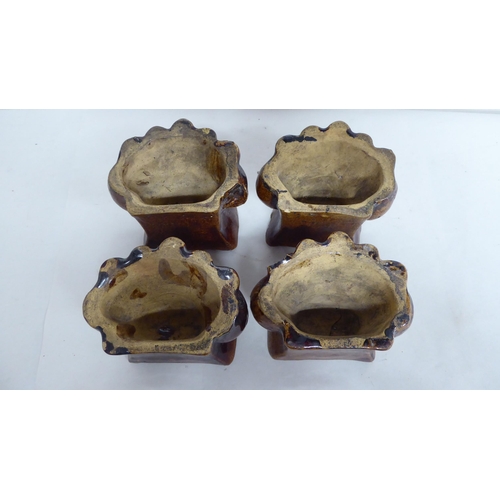 21 - A set of four pottery furniture risers  3.5