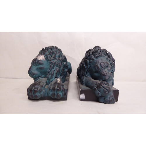 24 - A pair of 20thC overpainted, reconstituted stone recumbent lions, on plinths  5