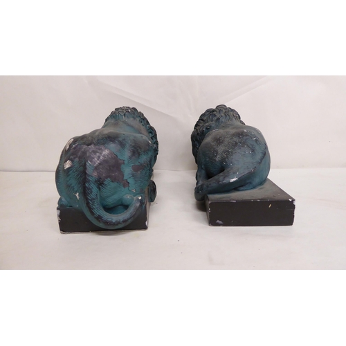 24 - A pair of 20thC overpainted, reconstituted stone recumbent lions, on plinths  5