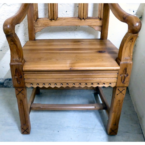 29 - A modern pine and oak framed ecclesiastically themed, open arm hall chair, the solid seat raised on ... 