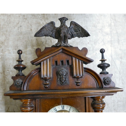 35 - A late 19th/early 20thC stained beech and mahogany cased wall clock, faced by a Roman dial  31