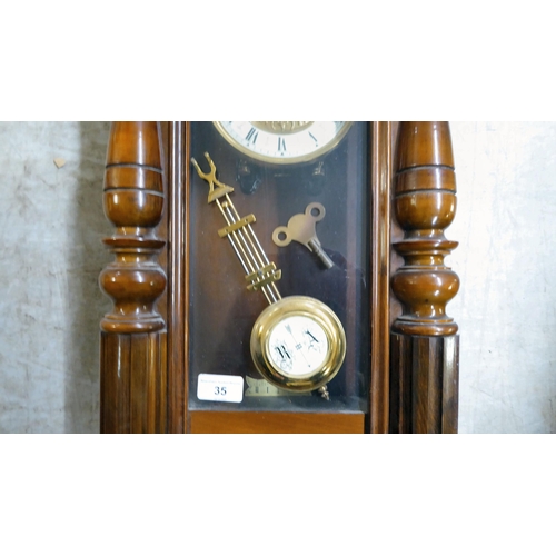 35 - A late 19th/early 20thC stained beech and mahogany cased wall clock, faced by a Roman dial  31