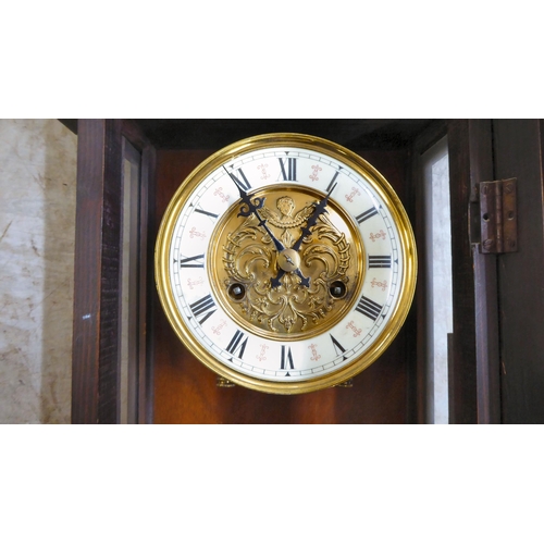 35 - A late 19th/early 20thC stained beech and mahogany cased wall clock, faced by a Roman dial  31