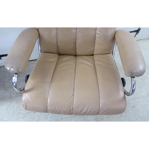 368 - A modern reclining chair, the chromium plated frame with cafe au lait coloured hide upholstery; and ... 