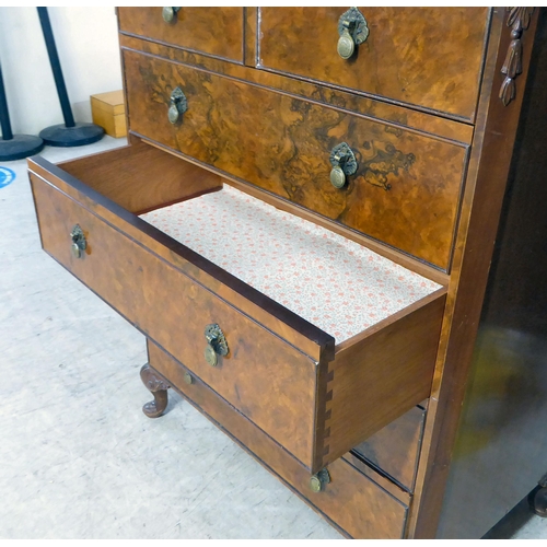 369 - A mid 20thC quarter veneered and walnut finished six drawer dressing chest, raised on stubby, carved... 