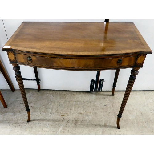 370 - A late 19thC crossbanded mahogany, bow breakfront single drawer side table, raised on tapered, reede... 