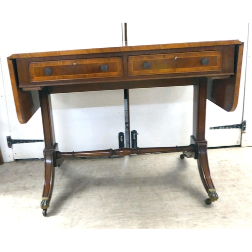 372 - A 20thC reproduction of a Regency inspired, string inlaid, mahogany sofa table with two frieze drawe... 