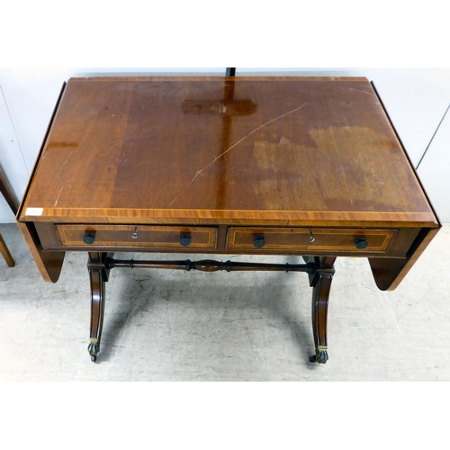 372 - A 20thC reproduction of a Regency inspired, string inlaid, mahogany sofa table with two frieze drawe... 