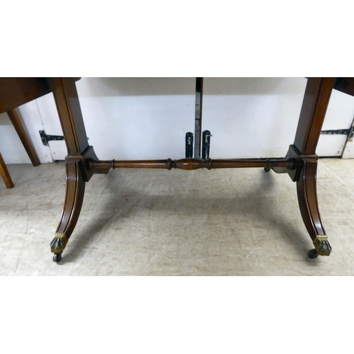 372 - A 20thC reproduction of a Regency inspired, string inlaid, mahogany sofa table with two frieze drawe... 