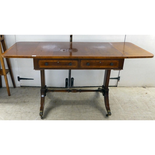 372 - A 20thC reproduction of a Regency inspired, string inlaid, mahogany sofa table with two frieze drawe... 