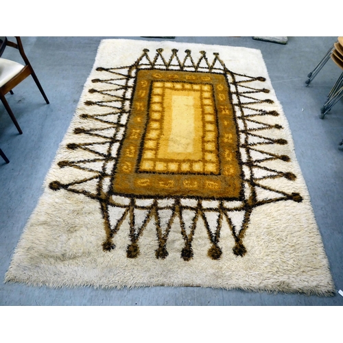 380 - A Swedish Rya rug  circa 1960s, decorated with a central rectangular panel, bordered by 'A' rep... 