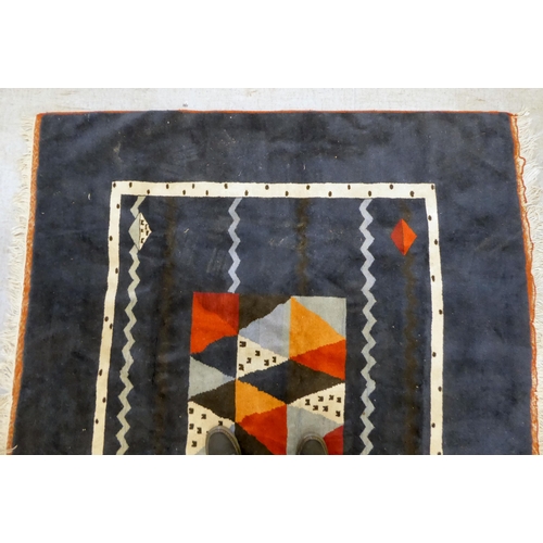 383 - A Caucasian rug, decorated with coloured diamond formation, on a dark blue ground  78