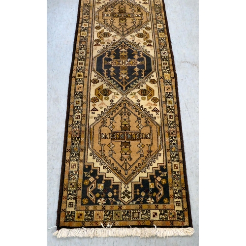 384 - A Meshkin, Persian runner, decorated with repeating designs, on a multi-coloured ground  27