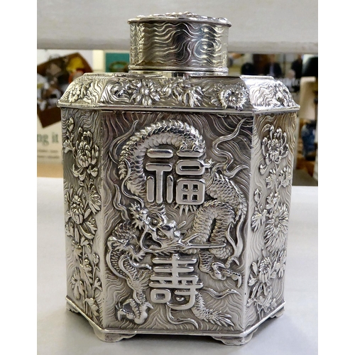 429 - A Chinese silver coloured, metal finished tea caddy of hexagonal form, decorated with text, dragons ... 