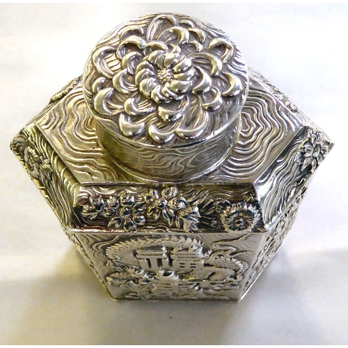 429 - A Chinese silver coloured, metal finished tea caddy of hexagonal form, decorated with text, dragons ... 