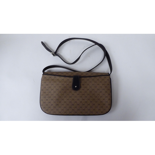 52 - A Gucci black leather and patterned fabric handbag, serial number 104.004.0024