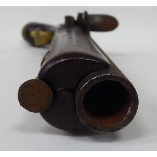 57 - An early 19thC flintlock pistol with a walnut stock