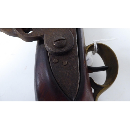 57 - An early 19thC flintlock pistol with a walnut stock