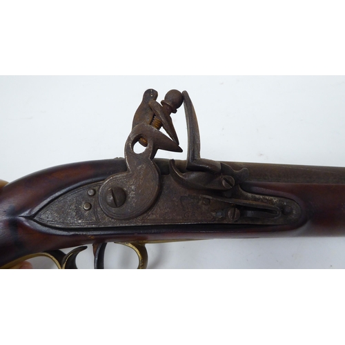 57 - An early 19thC flintlock pistol with a walnut stock