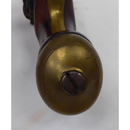 57 - An early 19thC flintlock pistol with a walnut stock