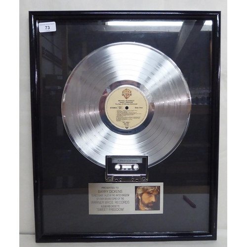 73 - A platinum sales award, presented to one Barry Dickens, celebrating over 300,000 sales of Michael Mc... 